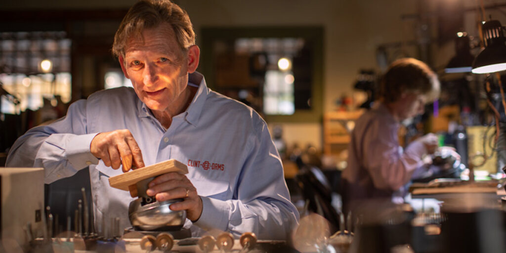 Clint Orms Engravers and Silversmiths working on a engraving project