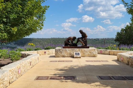 Bronze sculpture of Jesus washing a man's feet