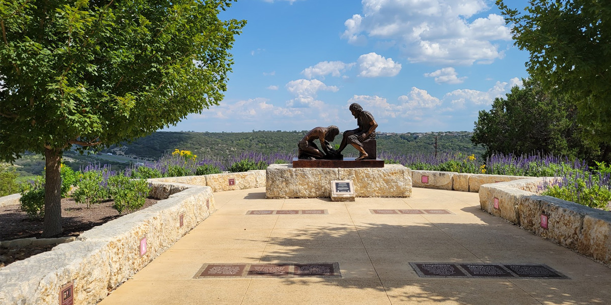 Bronze sculpture of Jesus washing a man's feet