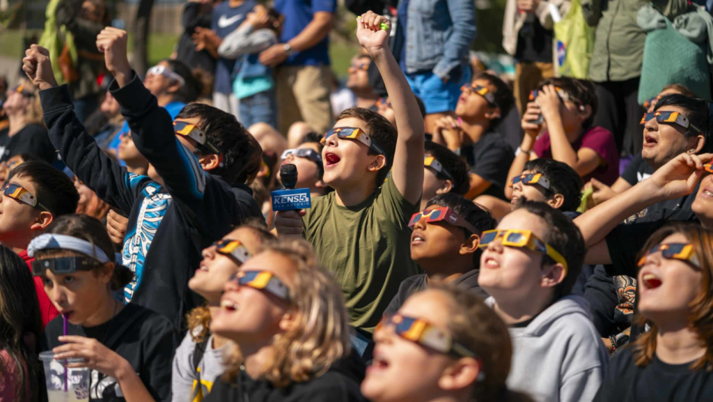 Group of people looking at Eclipse with glasses