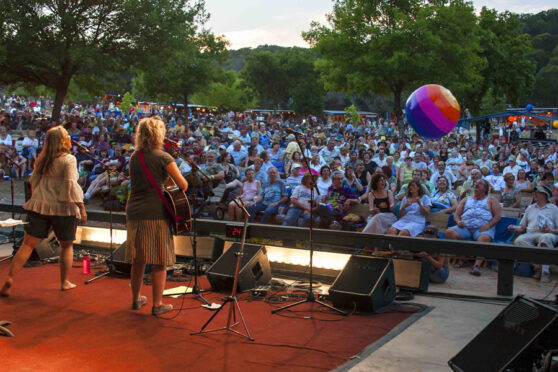 Sara Hickman and Kristin DeWitt perform before a packed audience at the Kerrville Folk Festival. Photograph by Susan Roads, Courtesy Mary Muse, Kerrville Folk Festival Foundation.
