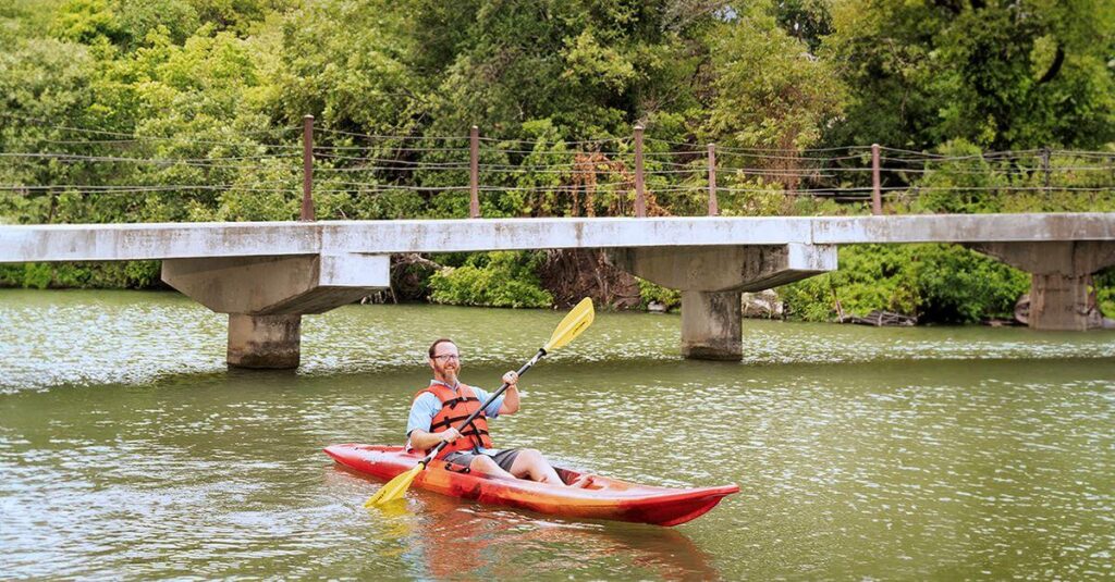 Man kayaking on river