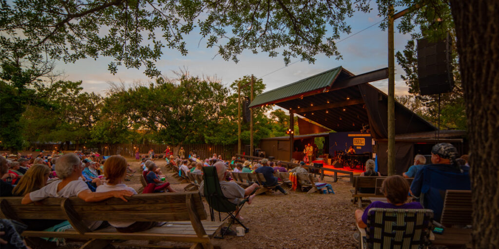 Audience listening to musicians on stage