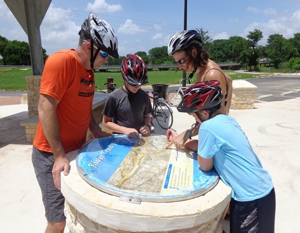 Family biking on trail