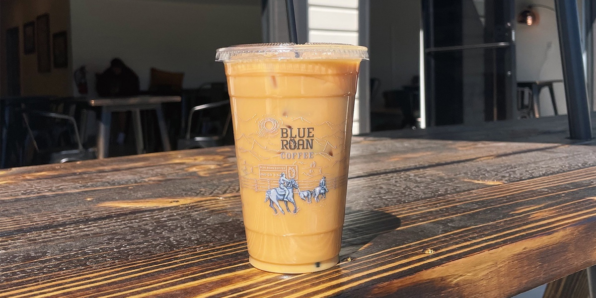 Iced coffee from Blue Roan sitting on a wooden table