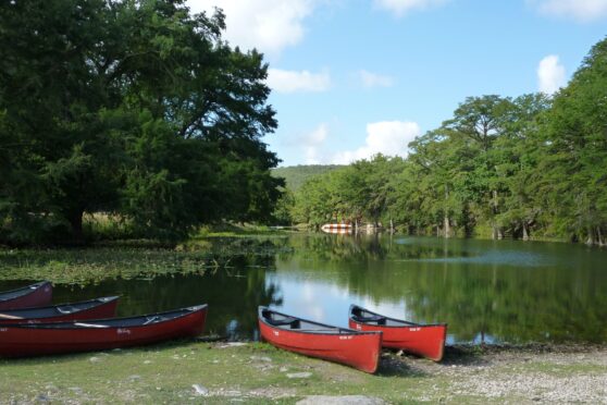 Camp Stewart river access with canoes