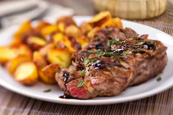 Cooked steak and potatoes on a plate