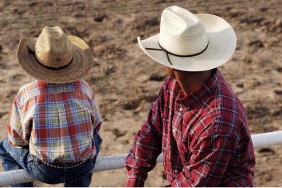 Father and son watching rodeo