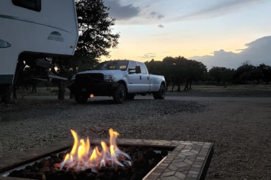 RV parking with truck near firepit