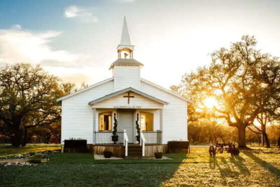 church with sunset behind it