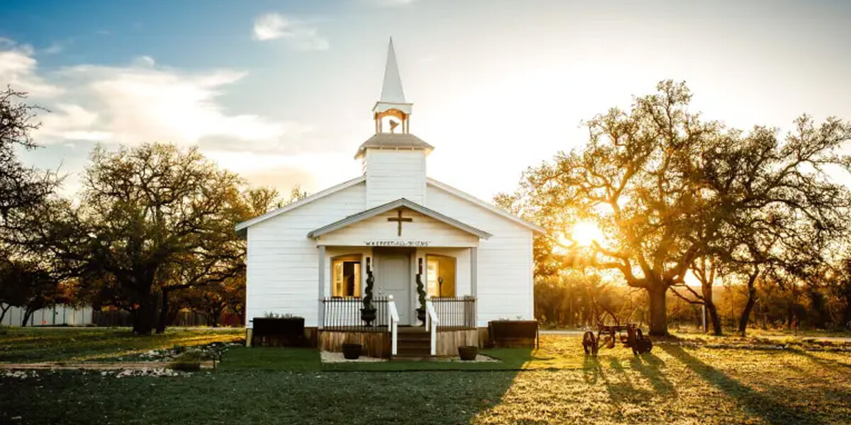 church with sunset behind it