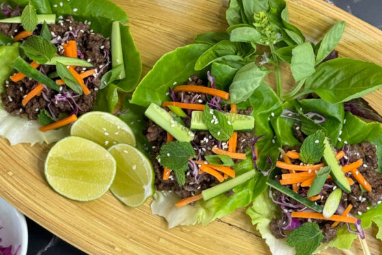 mixed greens salad on a bamboo tray