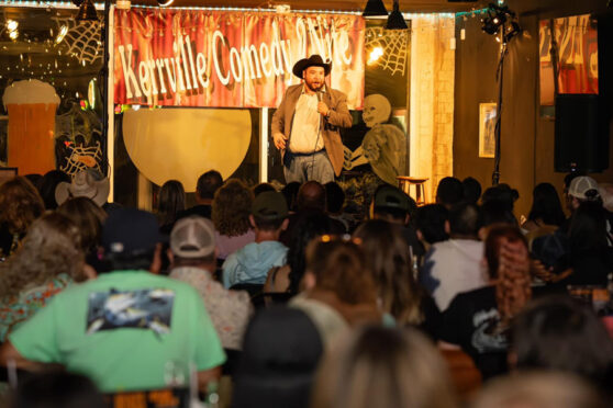 comic on stage in front of an audience