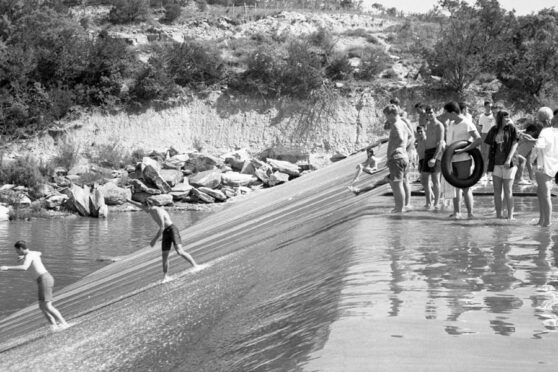 Kids sliding down Ingram Dam - Photo Credit: Joe Herring Jr.