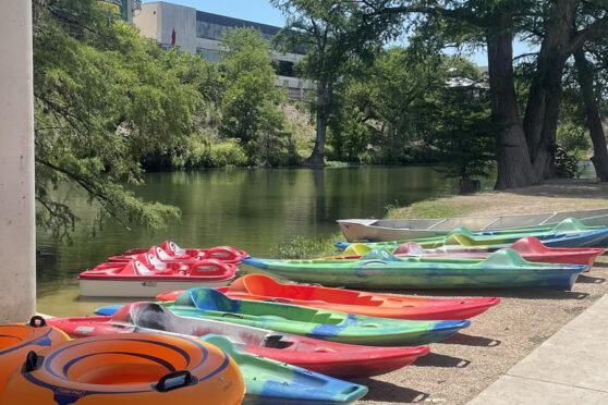 Kayaks and tubes near river