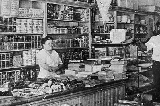 Original HEB food store interior with owner behind counter