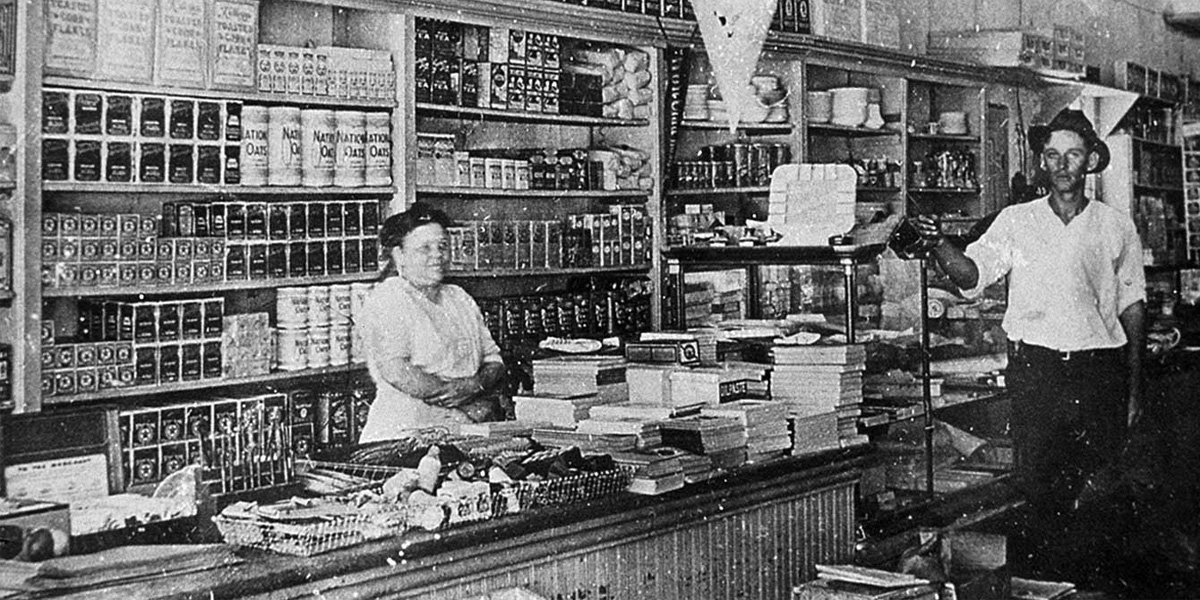 Original HEB food store interior with owner behind counter