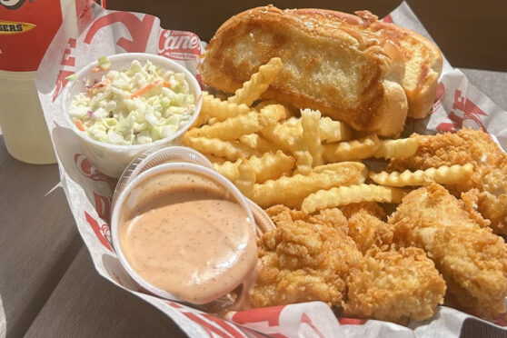 Raising Cane's Basket meal with sauce, chicken, fries, slaw
