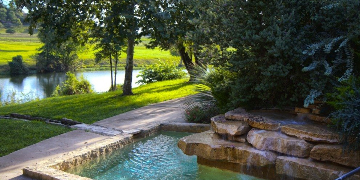 Shonto Ranch Cocktail Pool with green grass and trees surrounding