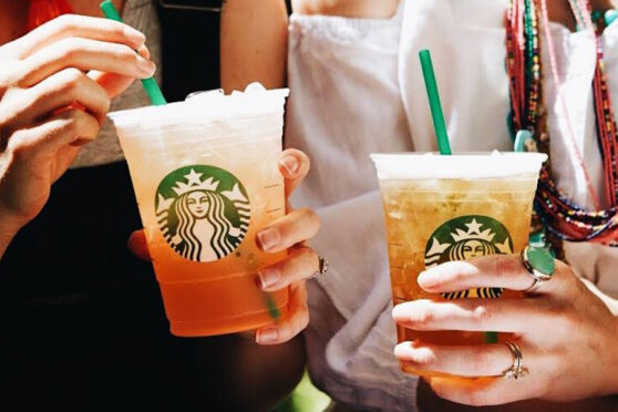 two people holding teas - Photo Credit: Starbucks