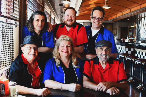 The New Buddy Holly Band posing in diner