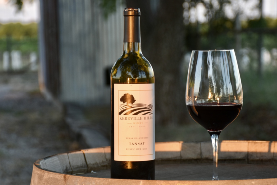 Wine bottle and glass on a barrel