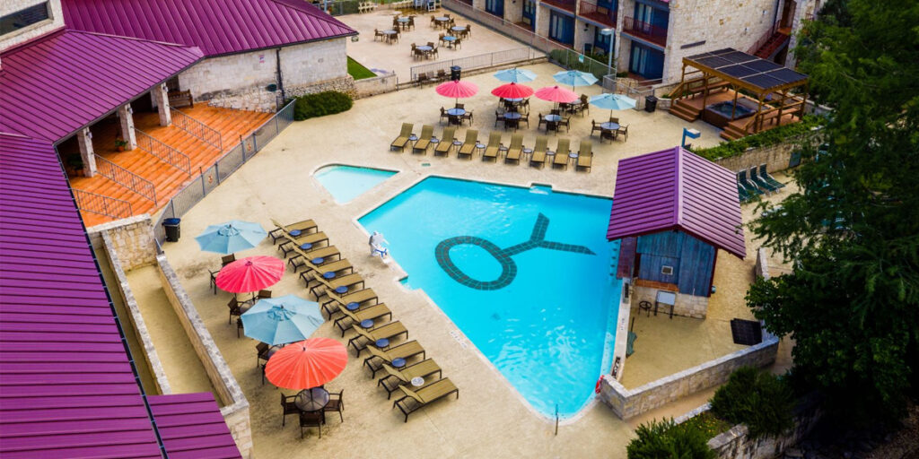 Outdoor pool with chairs on the sides and a Y.O. marking in the middle