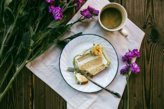 Slice of pastry on the table with orchids.