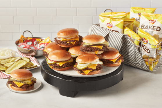 Catering order of burgers, chips and condiments.