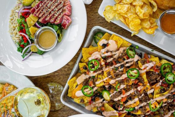Loaded nachos and spread of appetizers.