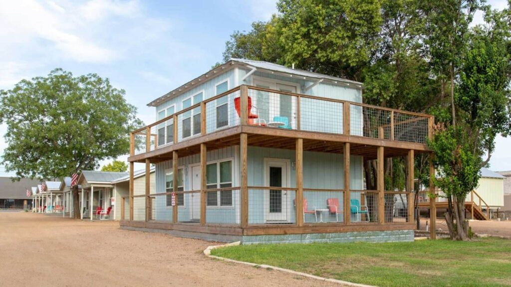River Trail Cottages blue two-story cottage with wooden deck