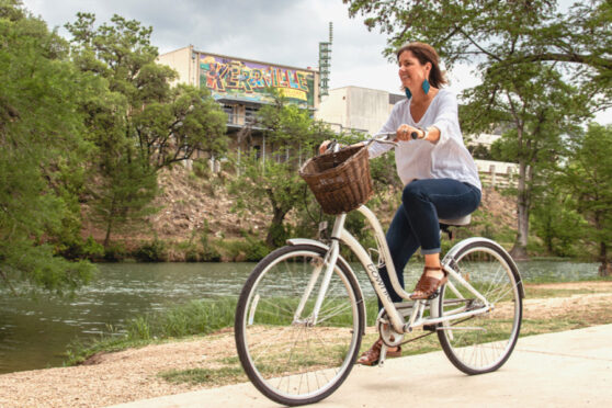 Woman on bike along river side