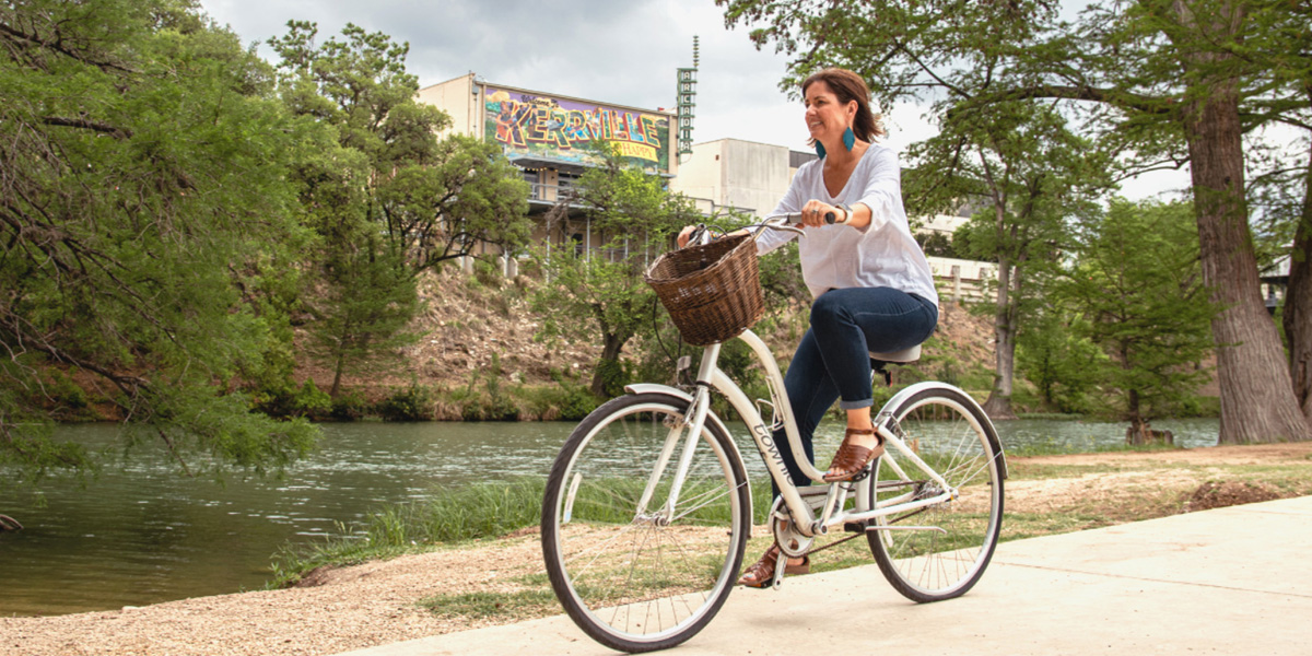 Woman on bike along river side