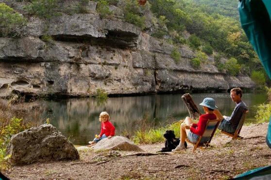 Family Camping near river outside a tent at Lost Maples State Natural Area - Photo Credit-Texas Parks and Wildlife