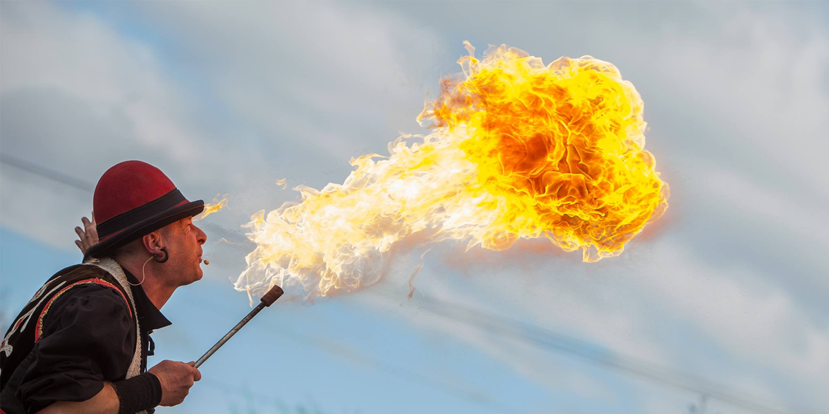 Firebreather performer spitting out fire