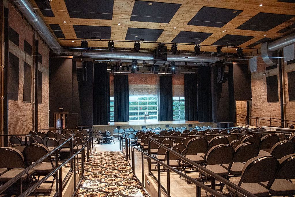 Interior of performing arts theater with seats in the back and stage in front