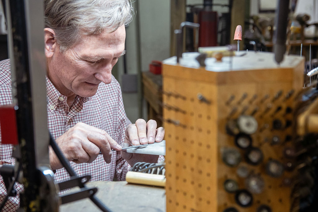 Local silversmith Clint Orms meticulously working on his artistic craft in his studio