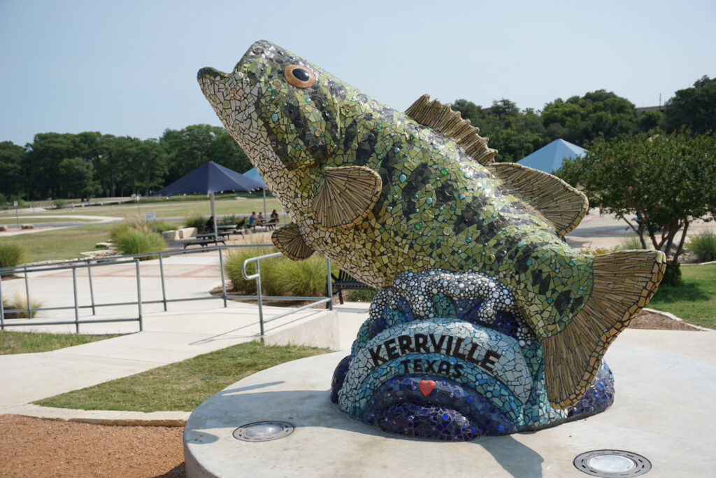 A mosaic sculpture of a Guadalupe Bass in Louise Hays Park