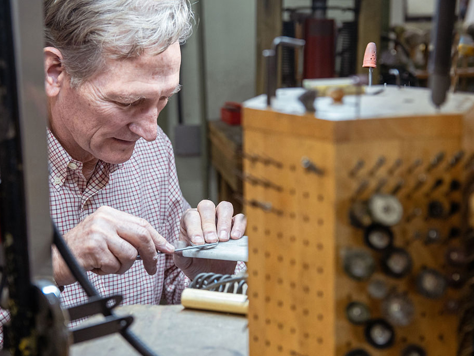 Local silversmith Clint Orms meticulously working on his artistic craft in his studio