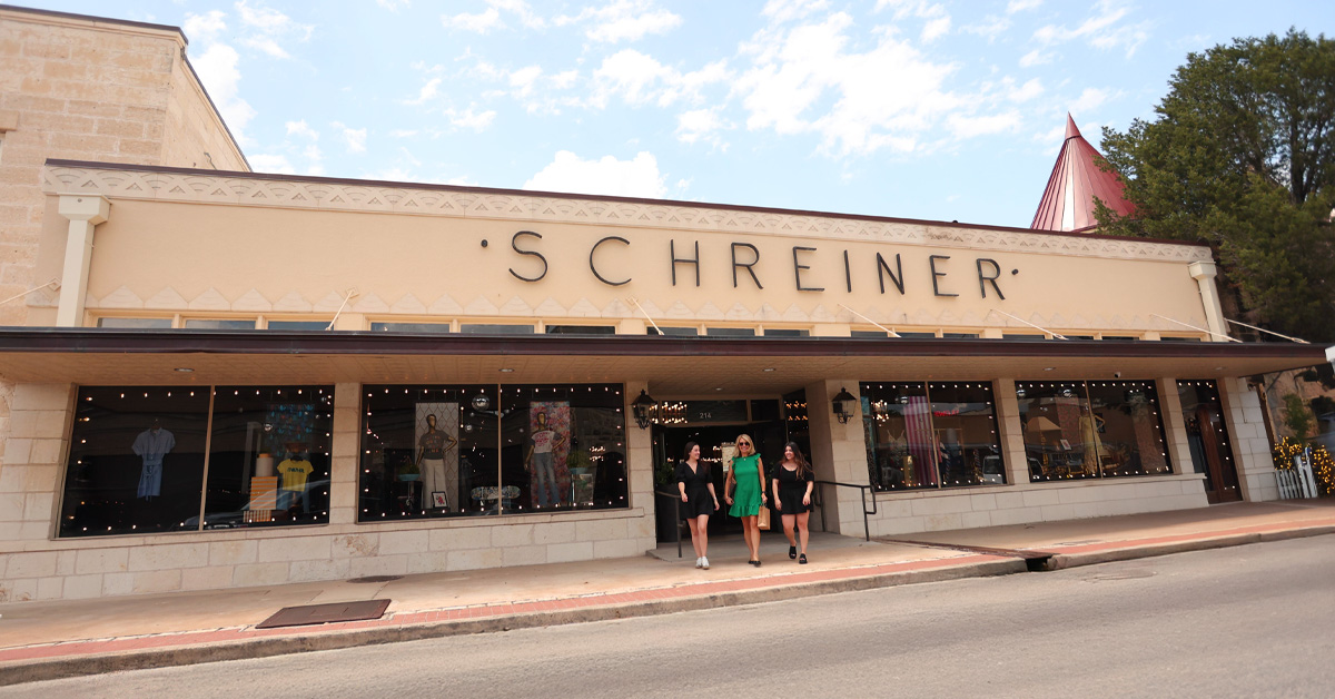 3 women walking out of Schreiner building