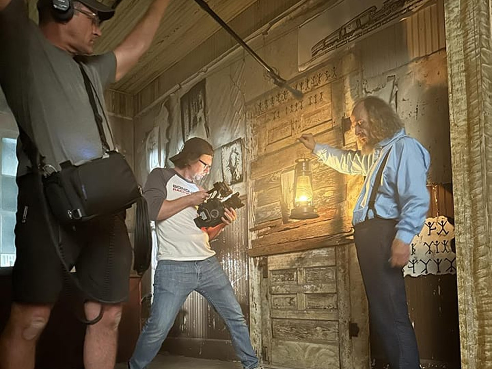 TriGoodwin Production is filming a scene with a man in an old house