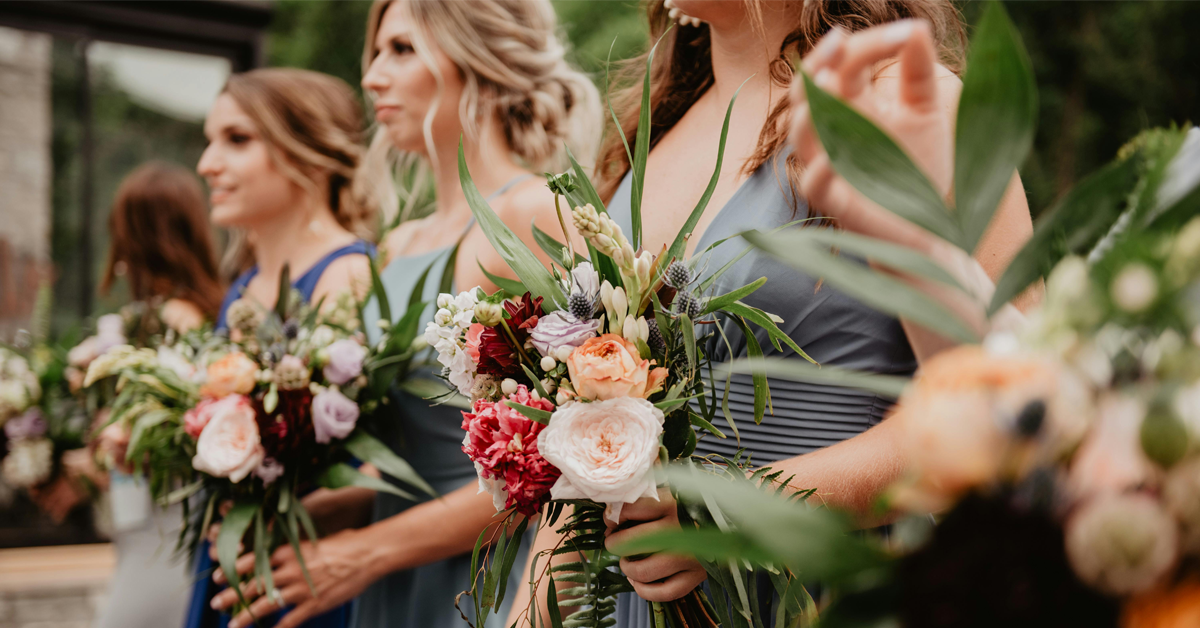 Wedding bridesmaids in a. row holding flowers