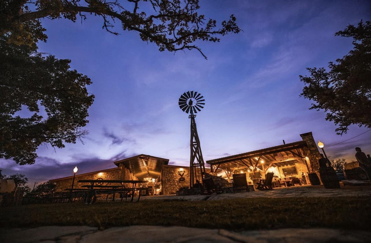 Y.O. Ranch Headquarters with windmill at dusk