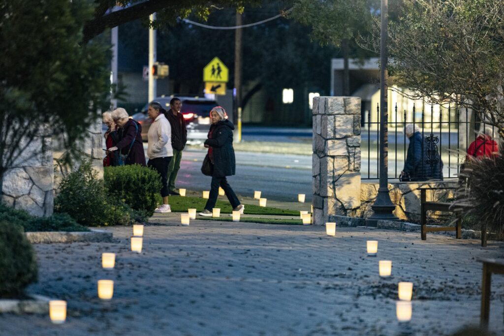 Annual Christmas church walk visitors walk down path