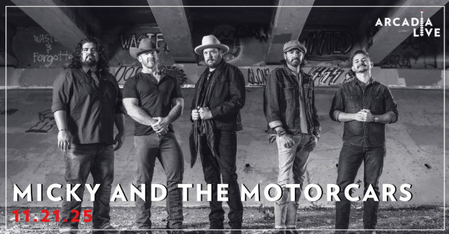 micky Micky and the Motorcars band posing under bridge