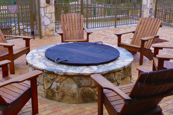 Adirondack Chairs surrounding a firepit